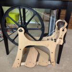 A Schacht Flatiron spinning wheel set up so the flyer is on the right.