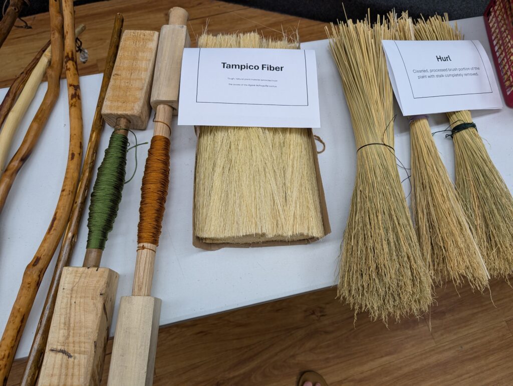 Left to right: the broomsticks, two broom spindles, a sheaf of tampico fiber, and three bundles of hurl.