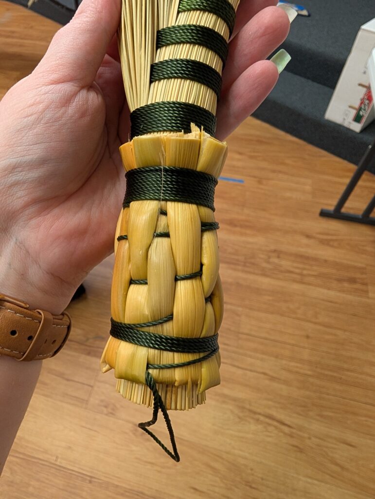 Close up of the woven handle of the completed demo hand broom.