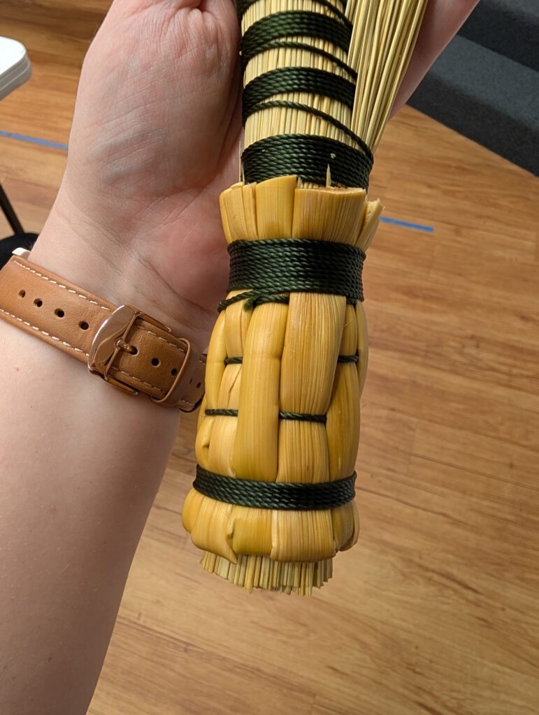 Close up of the woven handle of the completed demo hand broom.